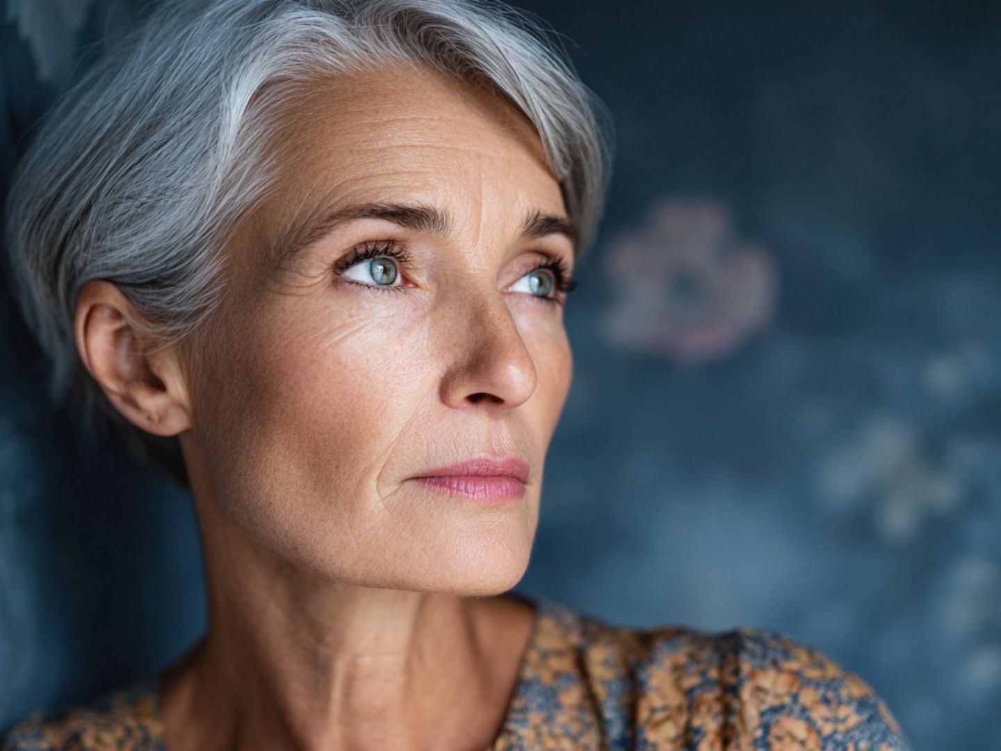 Woman in her fifties outdoors, relaxed and looking ahead